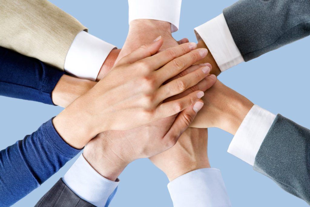 Photo of business peoples hands on top of each other